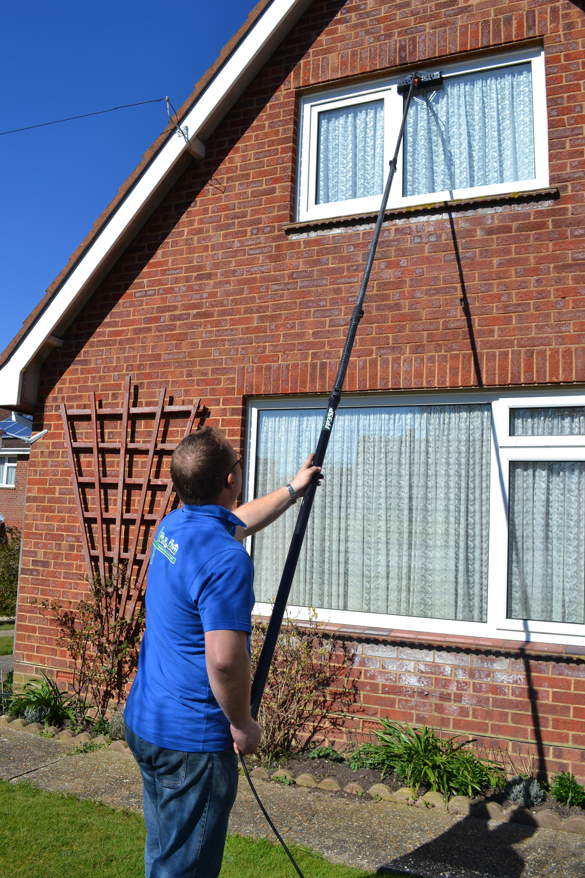 David Roberts washing upstairs windows with extendable wash brush